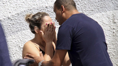 A man comforts a woman at the Raul Brasil State School in Suzano, Brazil, following the shooting. 