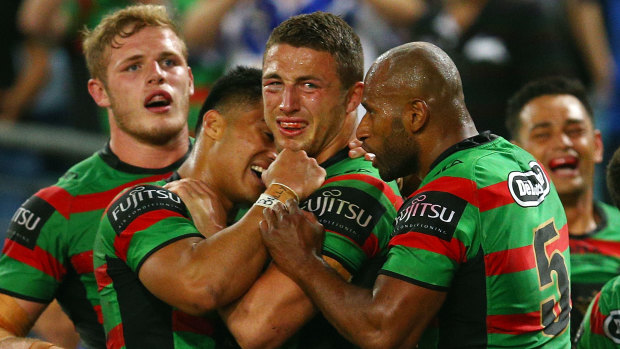 Lote Tuqiri shares a special moment with Sam Burgess and his Souths teammates during the 2014 NRL grand final.