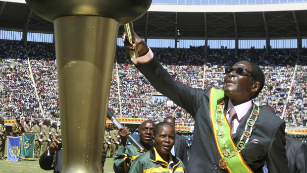 Mugabe lights a flame at celebrations to mark 32 years of independence of Zimbabwe in 2012. 