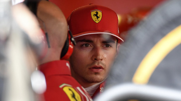 Ferrari's Monegasque driver Charles Leclerc reacts in the pits after he crashed. 