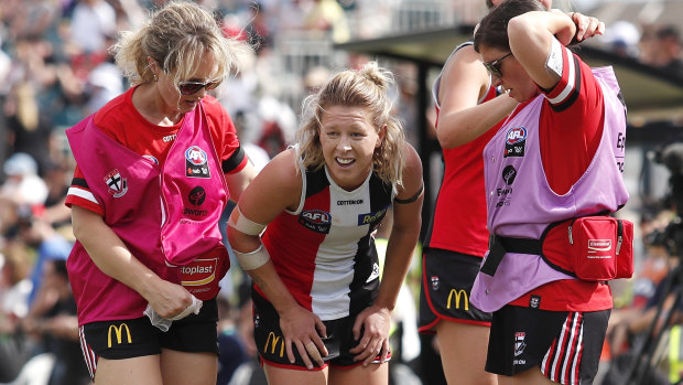Hobbling off: Kate McCarthy of the Saints leaves the field after suffering an injury.