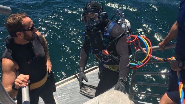 Sergeant Andy Bauer (left) with a police diver in open ocean.