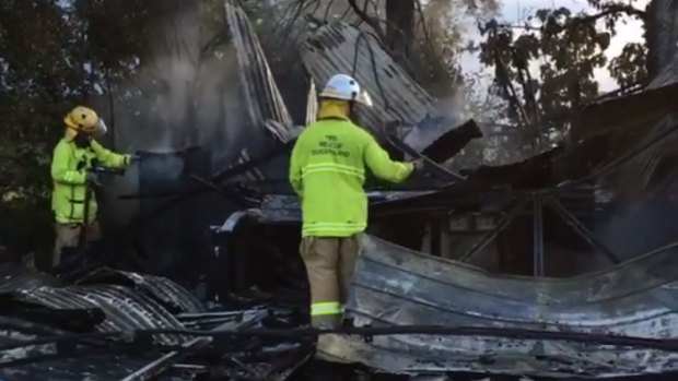 Lovestar owner Helen Bayley surveys the damage to her Moggill warehouse after a fire on Monday.