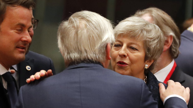 British Prime Minister Theresa May speaks with European Commission President Jean-Claude Juncker during a round table meeting at an EU summit in Brussels on Thursday.