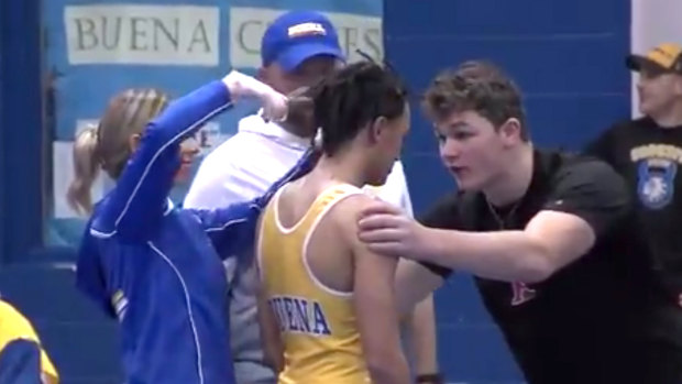 Outrage: High school wrestler Andrew Johnson gets his hair cut courtside minutes before his match in New Jersey.
