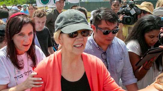 Democratic presidential candidate Senator Elizabeth Warren is swarmed by the media while walking past the Homestead Detention Centre, where the US is detaining migrant teens, in Homestead, Florida. 
