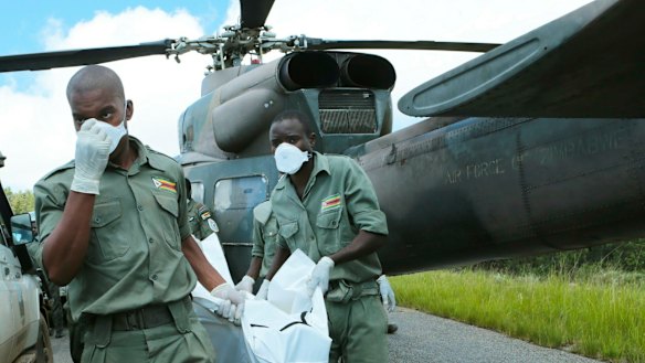 Personnel carry a body from a military helicopter in Chimanimani, about 600 kilometres south-east of Harare, Zimbabwe, on Wednesday.