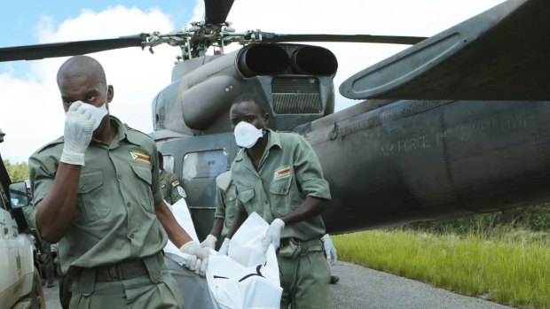 Personnel carry a body from a military helicopter in Chimanimani, about 600 kilometres south-east of Harare, Zimbabwe, on Wednesday.