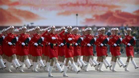Chinese female militia members march in formation during a parade to commemorate the 70th anniversary of the founding of Communist China.