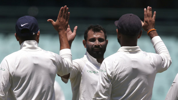 High five: Mohammed Shami, second left, celebrates after taking a wicket in Sydney on Friday.