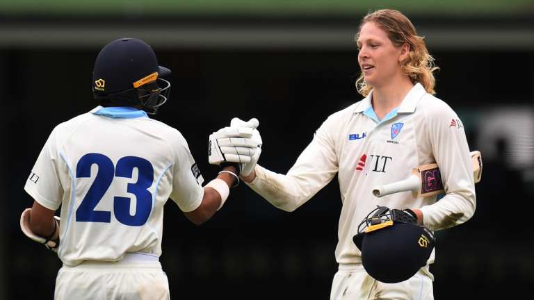 Centurions: Jack Edwards (right) is congratulated by Sangha after reaching his own milestone.