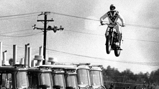 Evel Knievel jumps over 10 Mack trucks, but could he clear the gulf between economic rhetoric and reality?