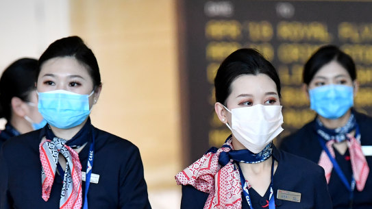 China Eastern Airlines cabin crew are seen wearing protective face masks at Brisbane International Airport on Wednesday..