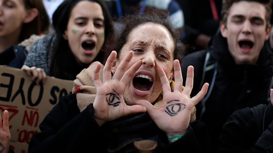 Protesters call for action outside the COP25 climate talks in Madrid.