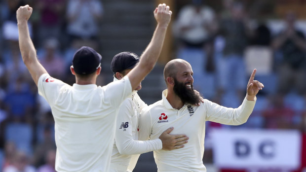 Moeen Ali (right) celebrates the wicket of John Campbell.