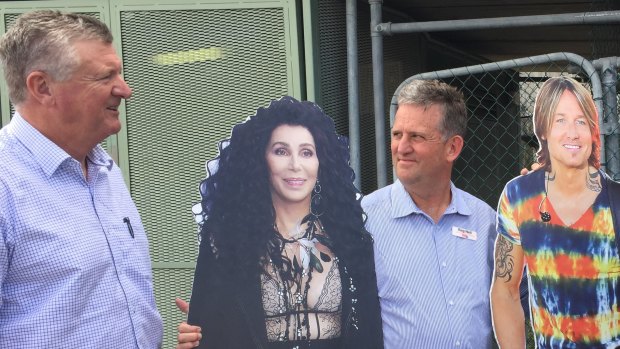 Labor lord mayoral candidate Pat Condren (left) and opposition leader Jared Cassidy brought Cher and Keith Urban cut-outs to a press conference to pledge the scrapping of councillor cab charges.