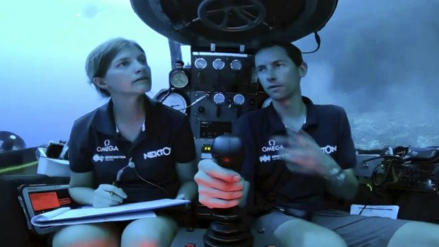 An image taken from a video issued by Nekton shows another crew: Lucy Woodall, Nekton Mission principle scientist alongside pilot Randy Holt inside a submersible 60 metres below the surface of the Indian Ocean.