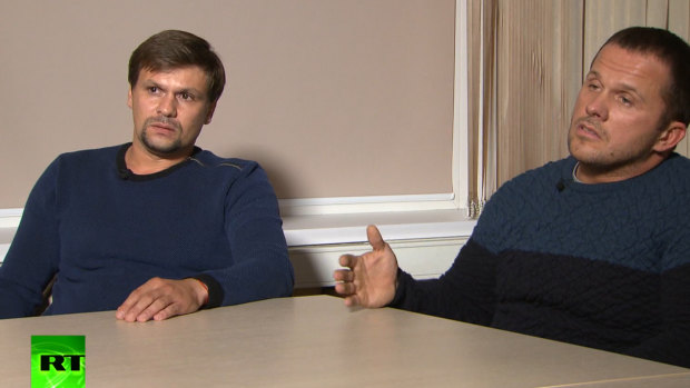 In this video grab provided by the RT channel , Ruslan Boshirov, left, and Alexander Petrov attend their first public appearance in an interview with the Kremlin-funded RT channel in Moscow, Russia.