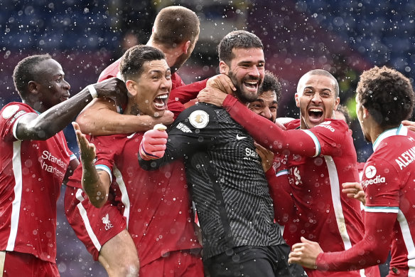 Liverpool’s goalkeeper Alisson Becker celebrates after scoring the winning goal.