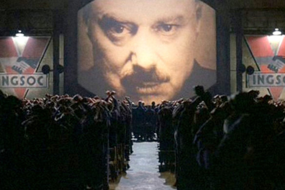 A still from the movie 1984, showing Big Brother and the masses.