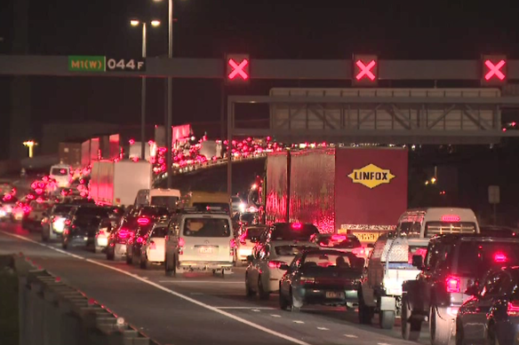 Traffic builds up on the West Gate Bridge after outbound lanes were closed on Monday evening because of a fire engulfing a public bus.