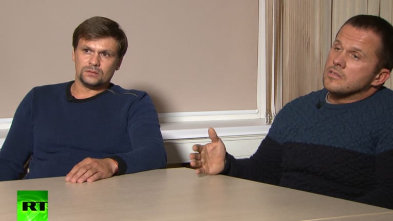 In this video grab provided by the RT channel , Ruslan Boshirov, left, and Alexander Petrov attend their first public appearance in an interview with the Kremlin-funded RT channel in Moscow, Russia.