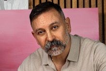 Joseph Hkeik painting at his Bowral home.