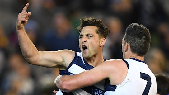 Geelong's Luke Dahlhaus, left, celebrates with Harry Taylor on the way to victory on Friday night.