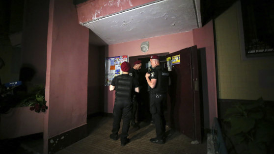 Police guard the front door of the Kiev apartment block where Arkady Babchenko reportedly died.