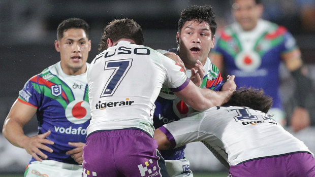 Wrapped up: Issac Luke of the Warriors is tackled by Brodie Croft and Felise Kaufusi.