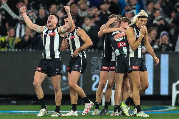 Jubilation: The Magpies after the final siren.