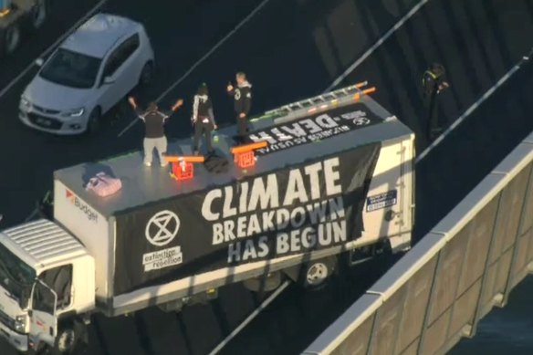 Climate protesters on the roof of the truck.