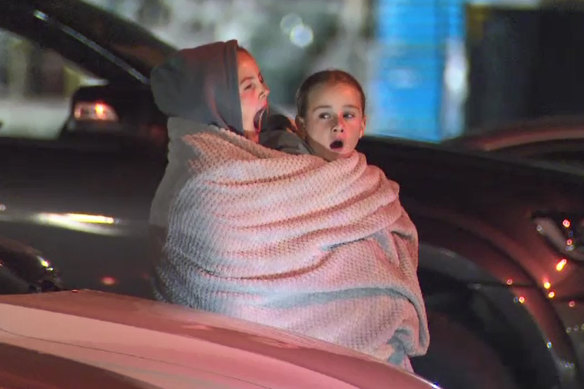 Fans were rugged up at Melbourne Airport in the middle of the night.