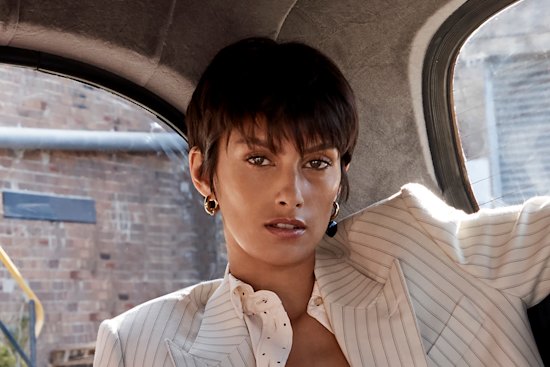 BLK DNM blazer, $2490, and trousers, $990. H&M shirt, $35. Eres “Parfumee” bra, $640. Earrings stylist’s own.