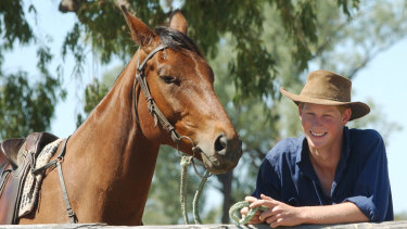 A young Prince Harry with his horse, Guardsman, during his gap year visit to Queensland in 2003.