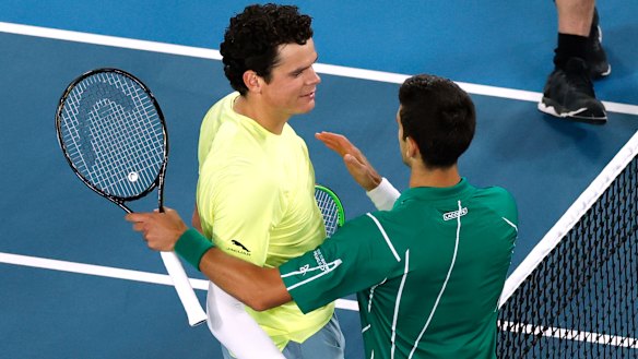 Djokovic beat big-serving Raonic to book a semi-final showdown with Federer.