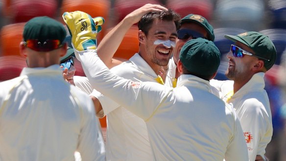 Smiling again: Mitchell Starc celebrates with teammates after bowling Vishwa Fernando.