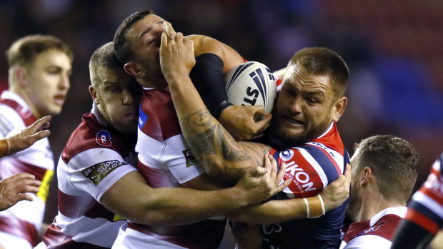 Sydney Roosters' Jared Waerea-Hargreaves is tackled during the bruising clash with the Warriors in Wigan.