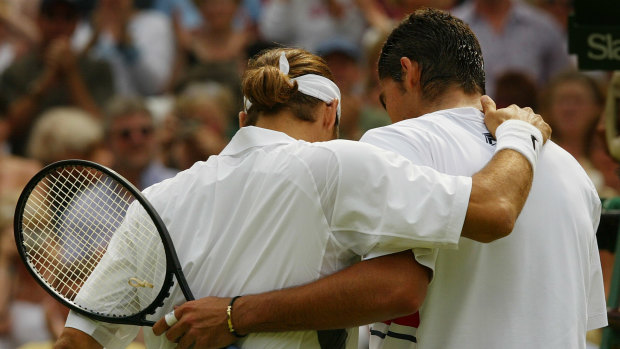 One that got away: Federer and Philippoussis embrace at the net after the men's singles final in 2003.