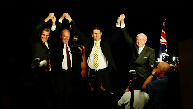 Deputy Prime Minister John Anderson, State Deputy Opposition leader Bob Quinn, state National Party leader Lawrence Springborg and Prime Minister John Howard saluting the party faithful at the 2004 campaign launch.