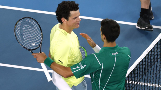 Djokovic beat big-serving Raonic to book a semi-final showdown with Federer.