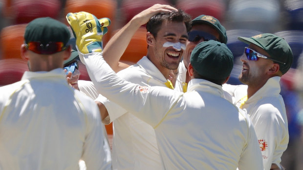 Smiling again: Mitchell Starc celebrates with teammates after bowling Vishwa Fernando.