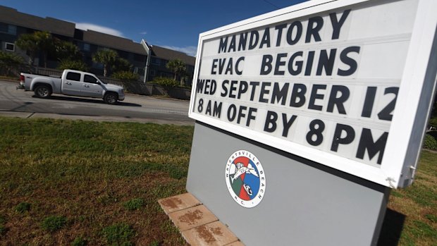 A sign warns residents about the mandatory evacuation in front of Wrightsville Beach Park in Wrightsville Beach, NC.