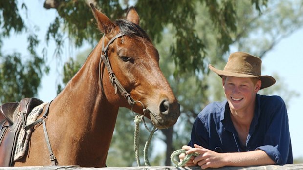 A young Prince Harry with his horse, Guardsman, during his gap year visit to Queensland in 2003.