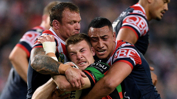 Wrapped up: Campbell Graham of the Rabbitohs is tackled by Jake Friend and Sio Siua Taukeiaho.