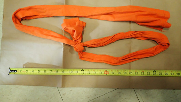 A piece of fabric used as a noose is displayed as part of the investigation into Epstein’s death.