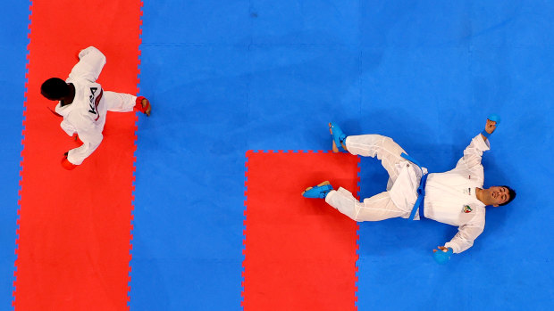 Ganjzadeh lays on the tatami after being floored by Hamedi. 