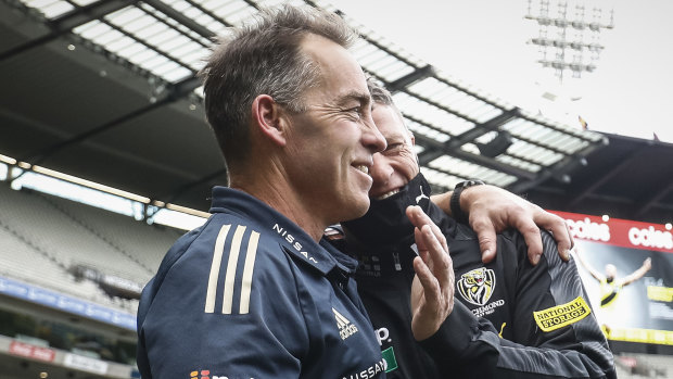 Alastair Clarkson and Damien Hardwick embrace after a dramatic draw.