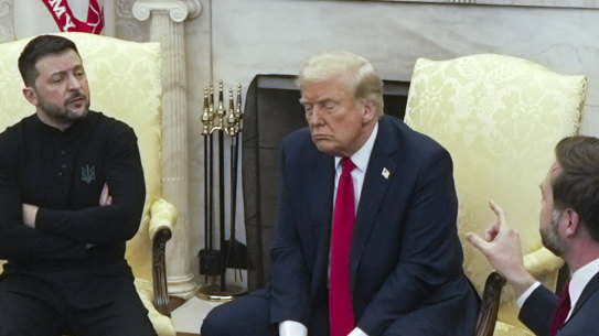 Vice President JD Vance, right, speaks with Ukrainian President Volodymyr Zelenskyy, left, as President Donald Trump listens.