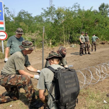 Members of the Hungarian Defence Force erecting a border fence in 2015 to stem a wave of refugees.